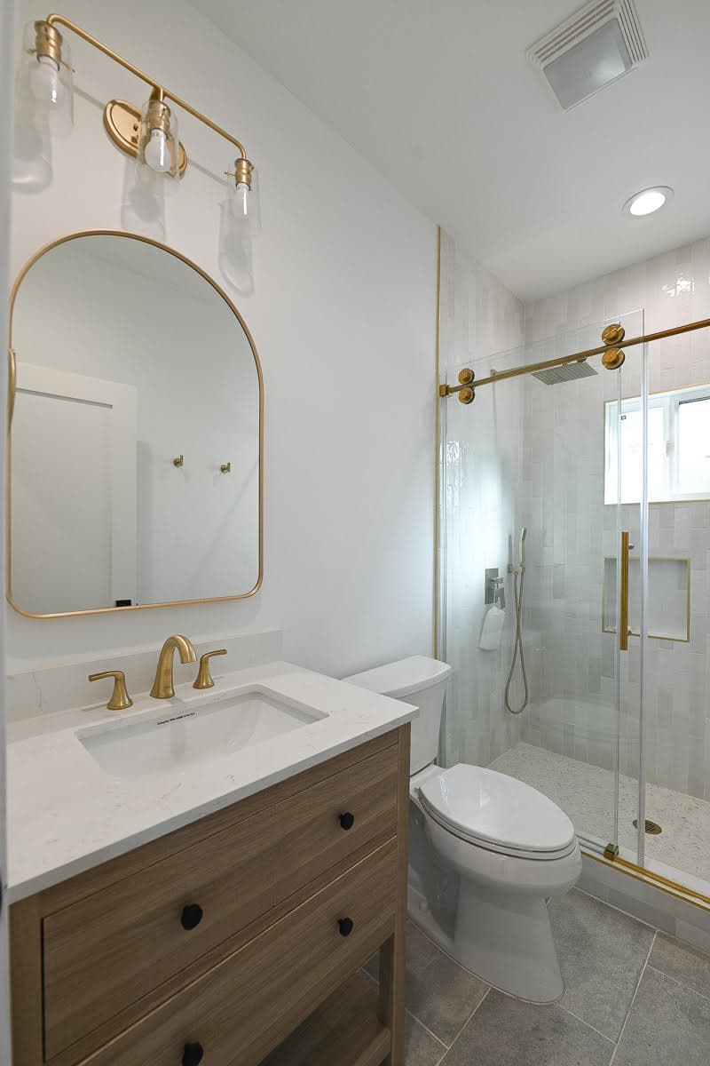 Luxury bathroom renovation with gold fixtures by Navarro's Custom Homes & ADUs in Los Angeles County