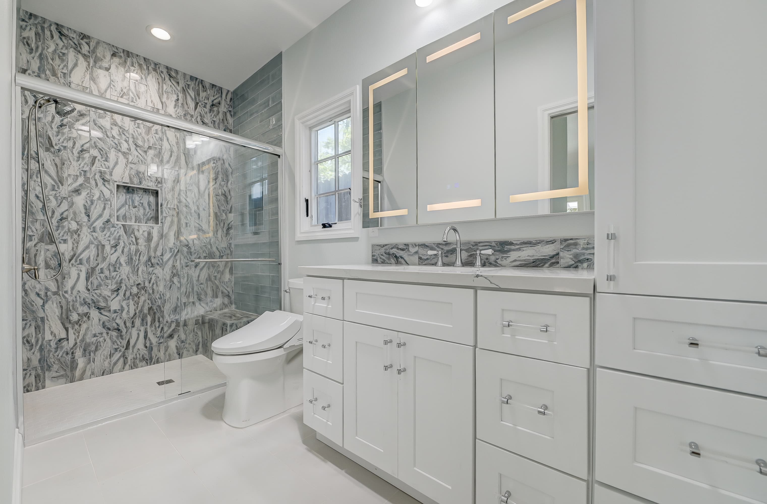 Luxury vanity with LED mirror and marble — Navarro's Custom Homes & ADUs