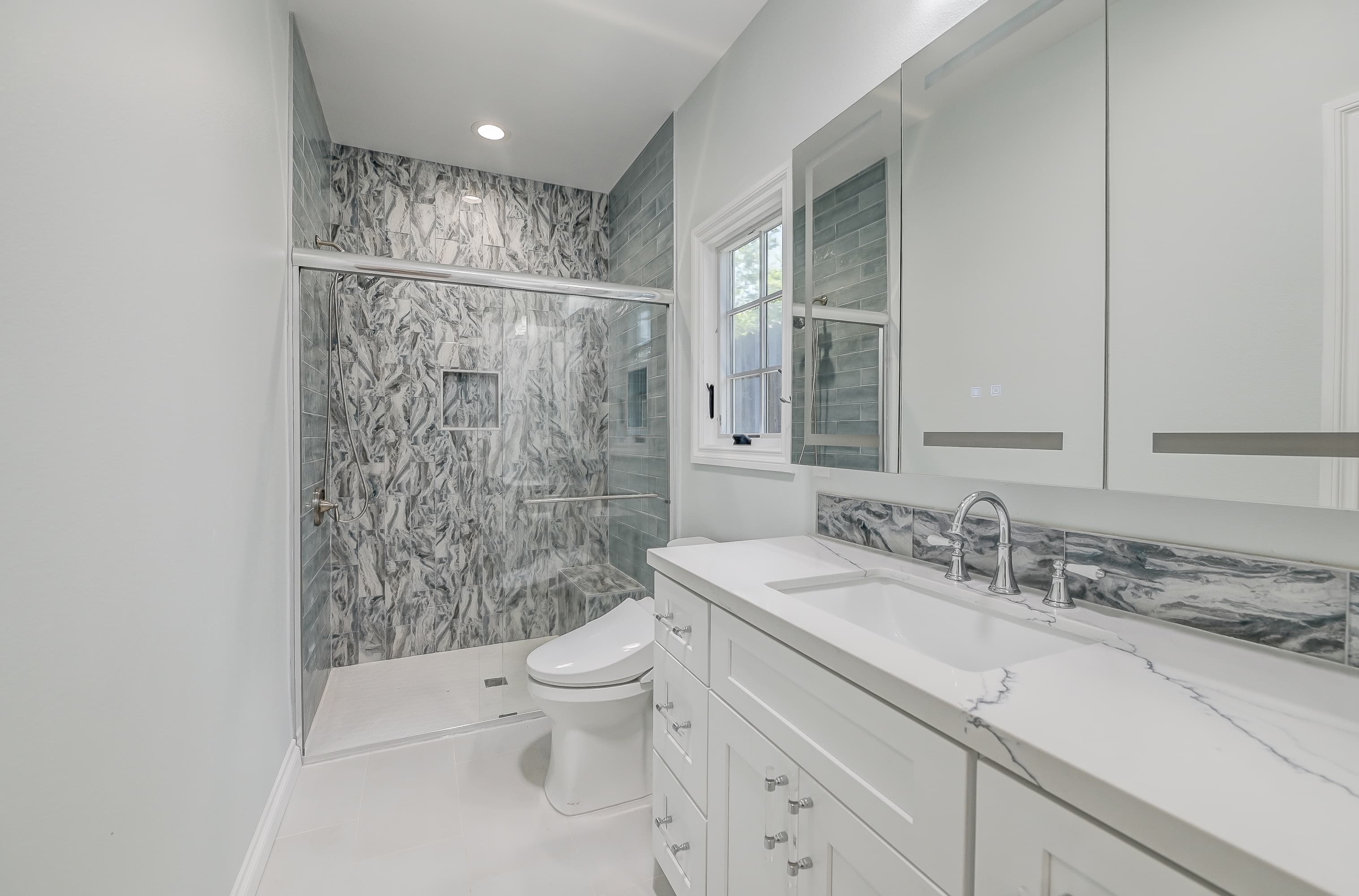 Modern marble walk-in shower — Navarro's Custom Homes & ADUs