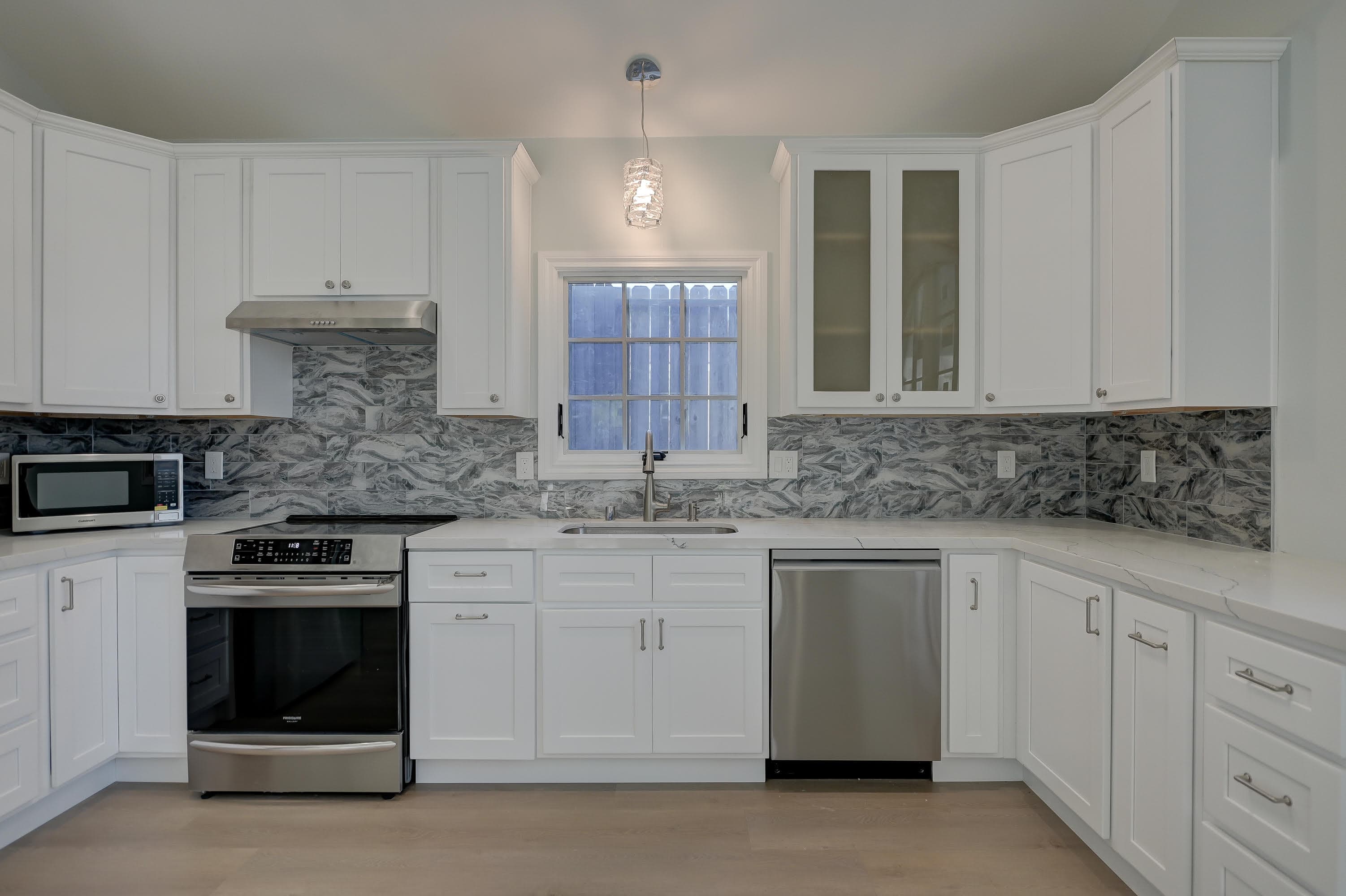 Luxury kitchen with white marble backsplash — Navarro's Custom Homes & ADUs